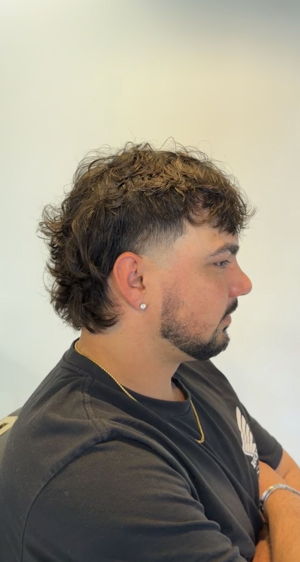 Textured curly mullet with a taper and shaped beard, cut at Studio K
